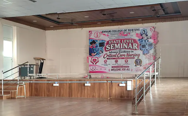 Stage of the Ennam Auditorium with the banner for the state level seminar on critical care nursing