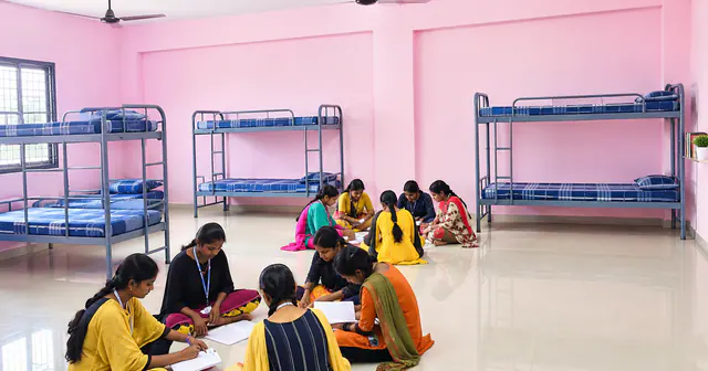 Students studying together in a hostel room