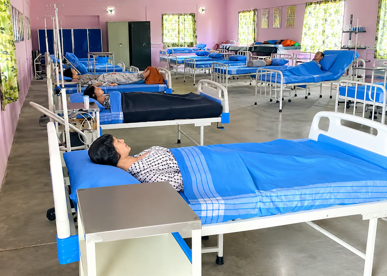 Hospital-style ward set up with beds and patient-care manikins for clinical practice