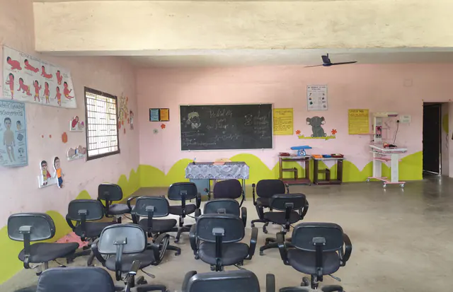 Seating, blackboard and wall charts in the paediatric nursing room