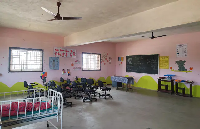 Paediatric nursing room with cots, seating and a blackboard