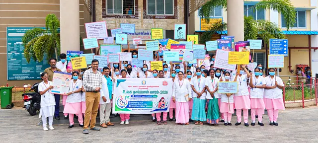 Nursing students holding health-awareness placards during World Breastfeeding Week