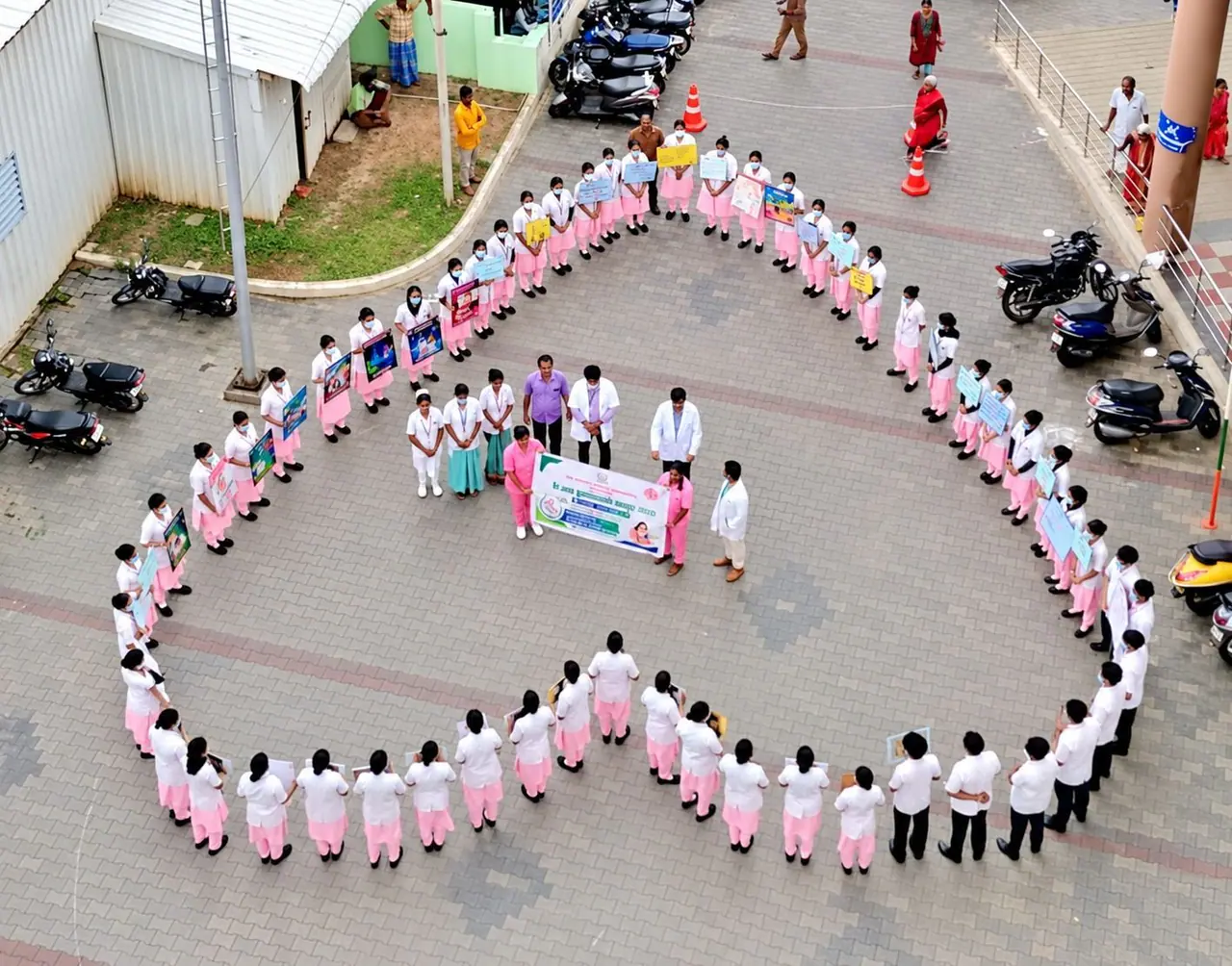 Aerial view of nursing students standing together in the shape of a heart