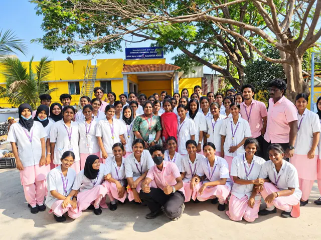Group photograph of nursing students in uniform with faculty